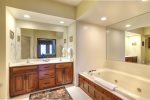 Master bath with jacuzzi tub and shower, twin sinks.